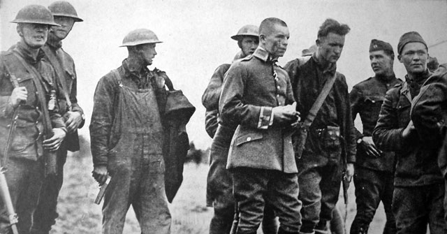 Marwede, with blood on his face, is led away by his American captors